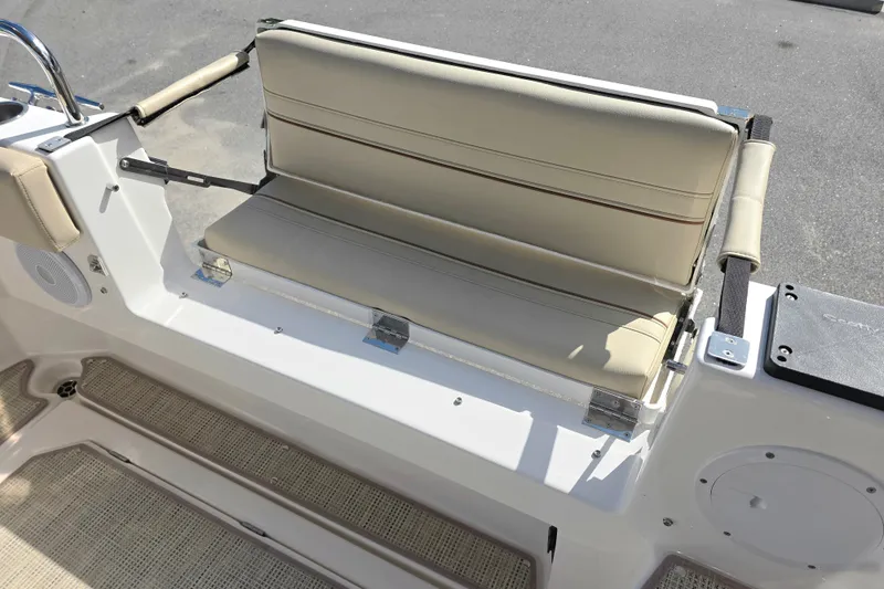 Slide: The Image of 2027 Cutwater C-32 Coupe boat seating area with beige cushions and stainless steel accents. - 6