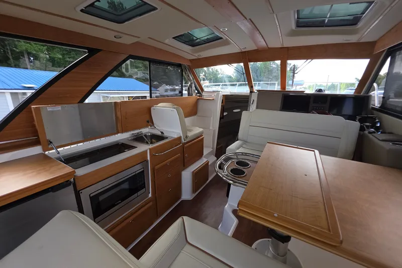 Slide: The Image of Interior of 2027 Cutwater C-32 Coupe, featuring modern kitchen and seating area. - 10