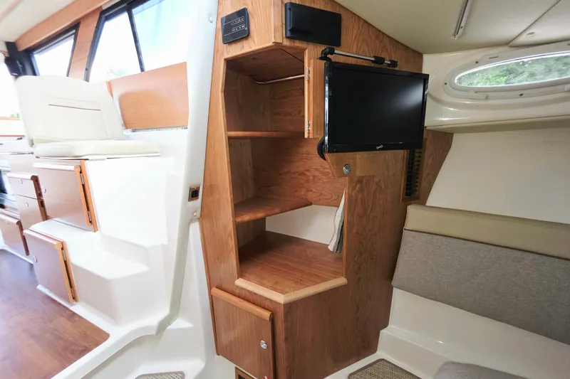 Slide: The Image of Interior of 2027 Cutwater C-32 Coupe featuring wooden cabinetry and mounted TV. - 19