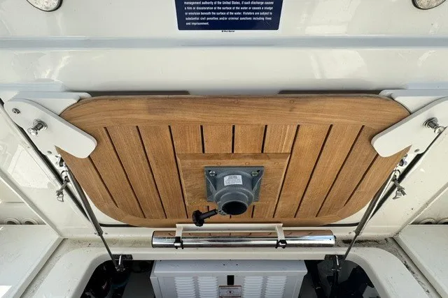 Slide: The Image of 2023 Boston Whaler 325 Conquest boat deck with wooden finish and metal fittings. - 53