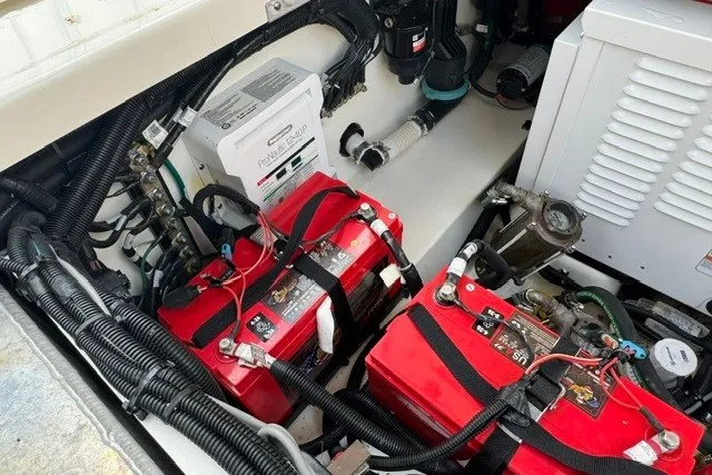 Slide: The Image of Engine compartment of 2023 Boston Whaler 325 Conquest with batteries and wiring. - 51