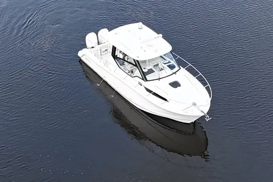 Slide: The Image of 2023 Boston Whaler 325 Conquest boat on calm water, aerial view. - 19