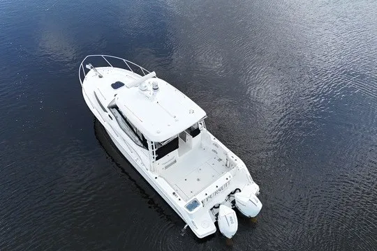 Slide: The Image of 2023 Boston Whaler 325 Conquest boat on calm water, aerial view. - 16