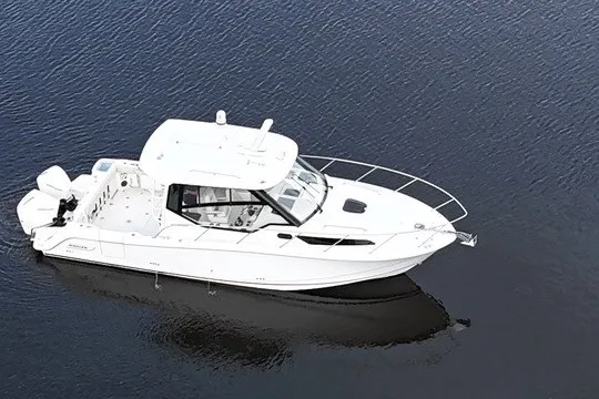 Slide: The Image of 2023 Boston Whaler 325 Conquest boat on calm water, showcasing sleek design and modern features. - 20