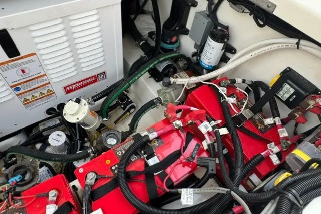 Slide: The Image of Engine compartment of a 2023 Boston Whaler 325 Conquest, showcasing wiring and components. - 52