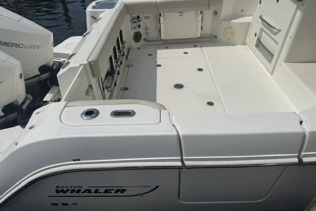 Slide: The Image of 2023 Boston Whaler 325 Conquest boat deck with Mercury engines, spacious and well-equipped. - 22