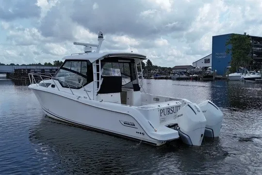 Slide: The Image of 2023 Boston Whaler 325 Conquest boat on water, featuring twin engines and sleek design. - 14