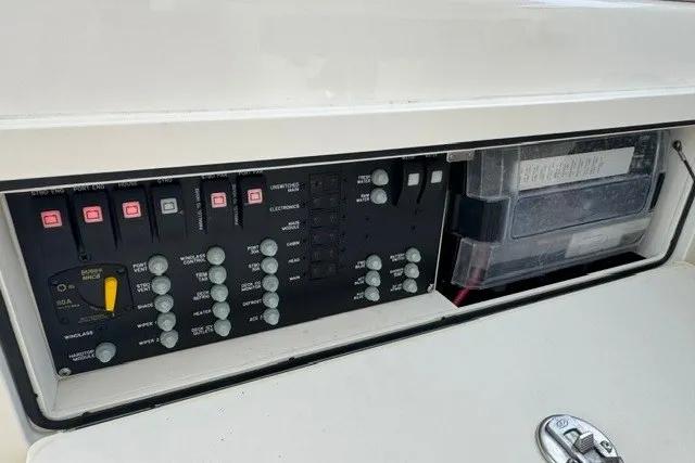 Slide: The Image of Control panel of 2023 Boston Whaler 325 Conquest boat, featuring switches and circuit breakers. - 34