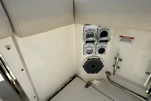 Slide: The Image of 2023 Boston Whaler 325 Conquest boat interior with electrical outlets and speaker. - 54