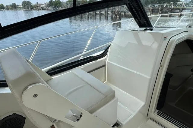 Slide: The Image of 2023 Boston Whaler 325 Conquest interior with seating, overlooking calm waters. - 32
