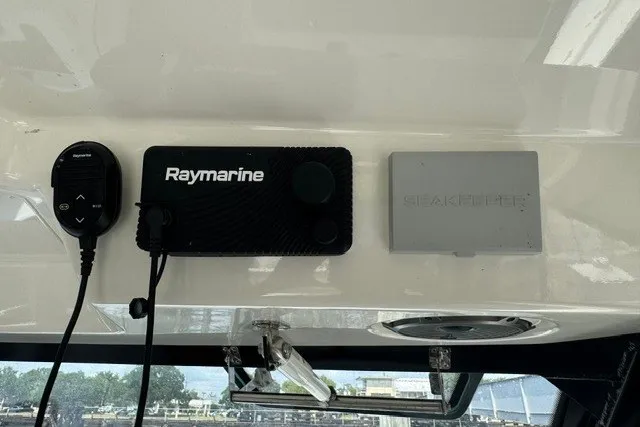 Slide: The Image of Raymarine and Seakeeper controls on 2023 Boston Whaler 325 Conquest boat dashboard. - 39