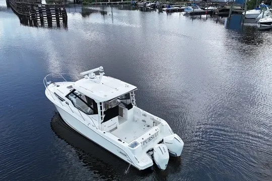 Slide: The Image of 2023 Boston Whaler 325 Conquest boat on calm water, aerial view. - 15