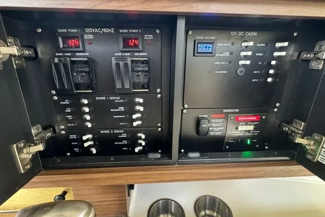Slide: The Image of Electrical control panel on 2023 Boston Whaler 325 Conquest boat, featuring various switches and gauges. - 46