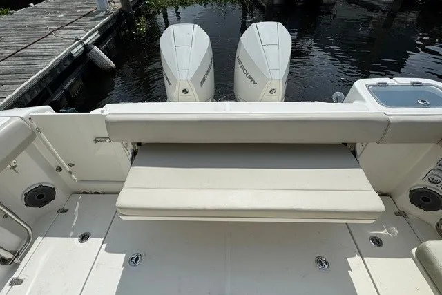 Slide: The Image of 2023 Boston Whaler 325 Conquest boat with dual Mercury engines at dock. - 26