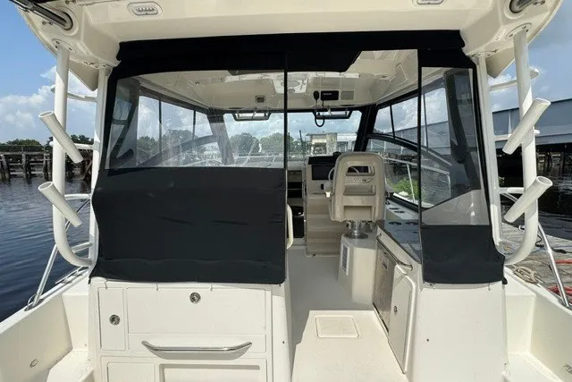 Slide: The Image of 2023 Boston Whaler 325 Conquest boat interior with helm and seating area. - 28