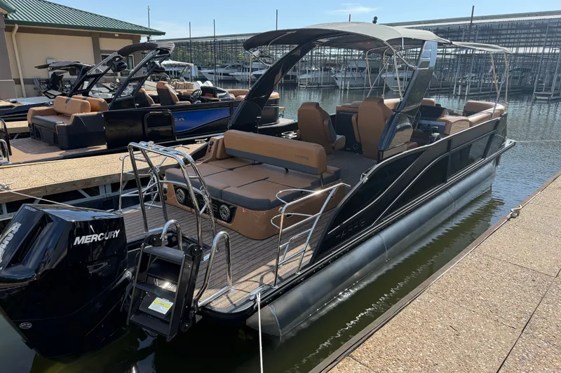 Slide: The Image of 2027 Harris Grand Mariner 250 SLDH pontoon boat docked, featuring sleek design and Mercury engine. - 3