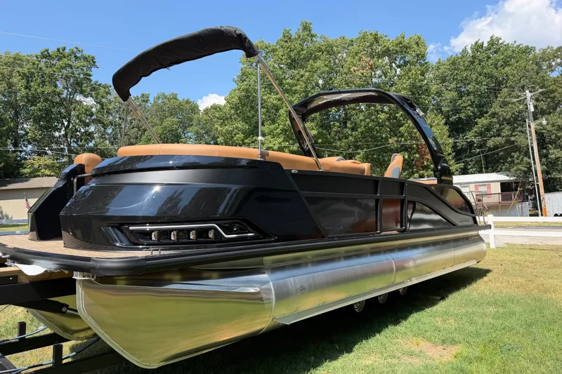 Slide: The Image of 2027 Harris Grand Mariner 250 SLDH pontoon boat on grass, sleek design, sunny day. - 12