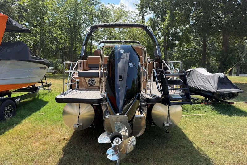 Slide: The Image of 2027 Harris Grand Mariner 250 SLDH pontoon boat on grassy area, rear view. - 14