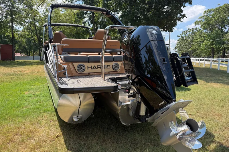 Slide: The Image of 2027 Harris Grand Mariner 250 SLDH pontoon boat with powerful outboard motor on grassy area. - 13