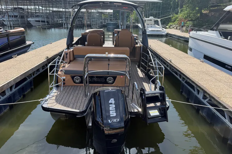 Slide: The Image of 2027 Harris Grand Mariner 250 SLDH pontoon boat docked at marina. - 2