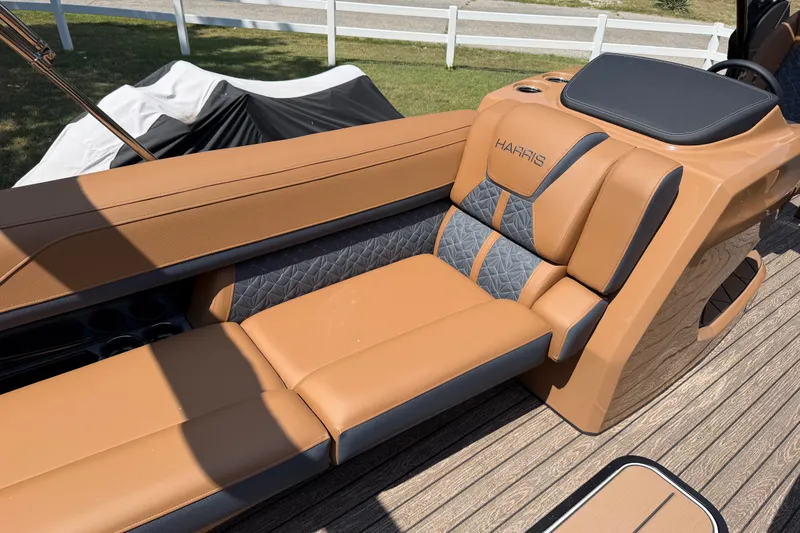 Slide: The Image of Luxurious seating on 2027 Harris Grand Mariner 250 SLDH boat, featuring tan and gray upholstery. - 22