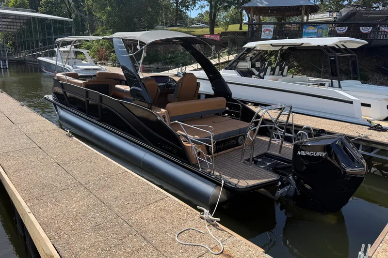 Slide: The Image of 2027 Harris Grand Mariner 250 SLDH pontoon boat docked with Mercury engine. - 1