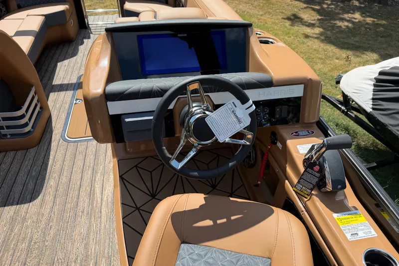 Slide: The Image of Steering console of 2027 Harris Grand Mariner 250 SLDH boat with modern controls and seating. - 17
