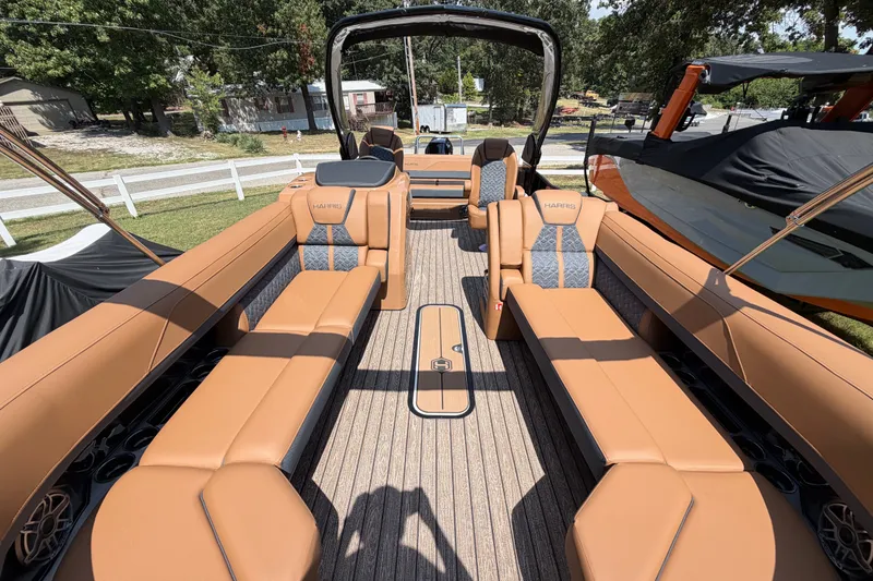 Slide: The Image of 2027 Harris Grand Mariner 250 SLDH pontoon boat with luxurious tan seating and spacious deck. - 25