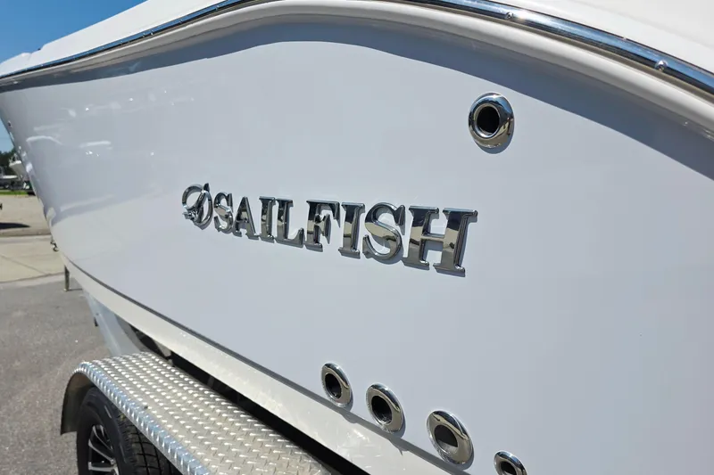 Slide: The Image of 2027 Sailfish 252 CC boat with chrome logo on white hull. - 20