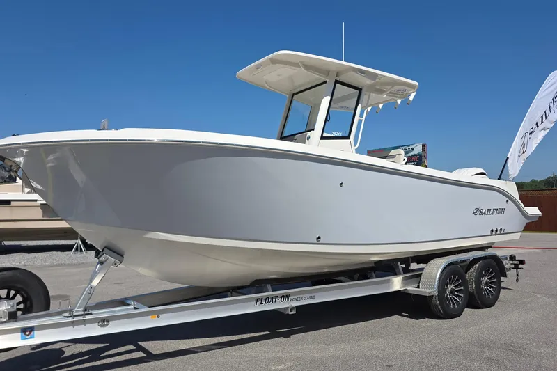 The Image of 2027 Sailfish 252 CC boat on trailer, displayed outdoors under clear blue sky. - 0