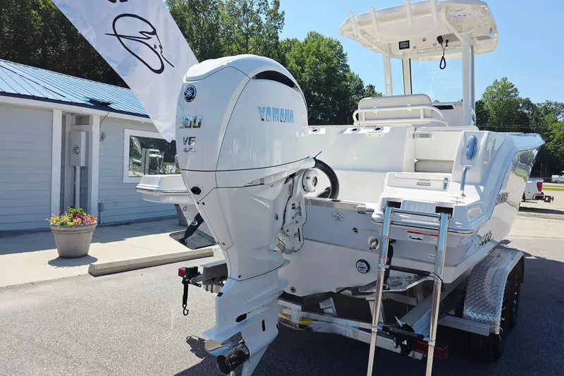 Slide: The Image of 2027 Sailfish 252 CC boat with Yamaha V6 engine on trailer, outdoor display. - 19
