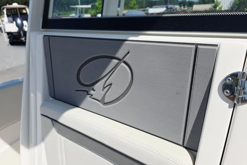 Slide: The Image of 2027 Sailfish 252 CC boat interior detail with embossed logo and sleek design. - 16