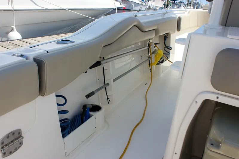 Slide: The Image of 2022 Key West 263 FS boat interior with storage compartments and cleaning equipment. - 17