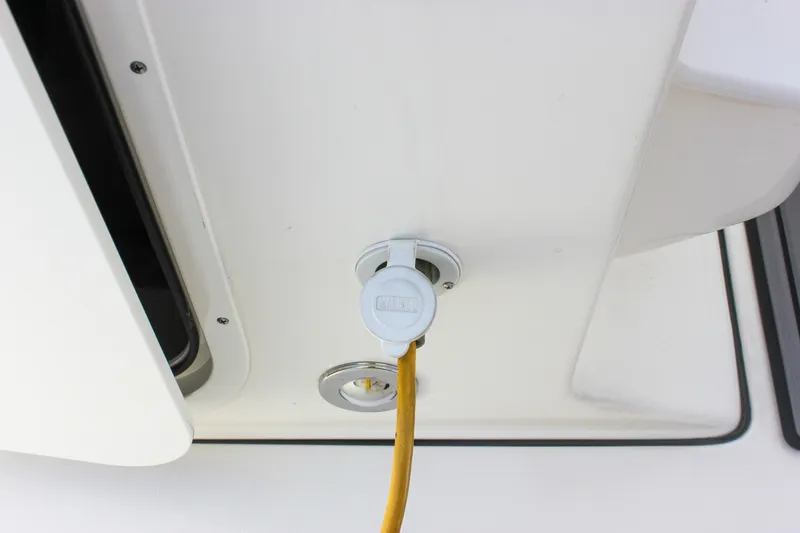 Slide: The Image of 2022 Key West 263 FS boat power outlet with yellow cable connection. - 26