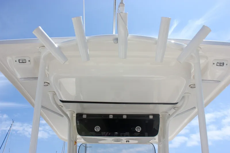 Slide: The Image of 2022 Key West 263 FS boat's T-top with rod holders against a clear blue sky. - 18