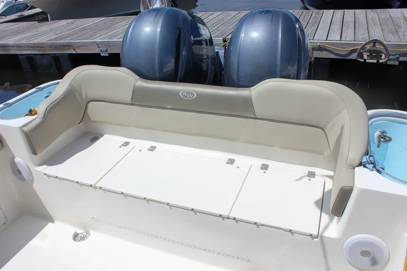 Slide: The Image of 2022 Key West 263 FS boat with cushioned seating and dual outboard motors. - 8