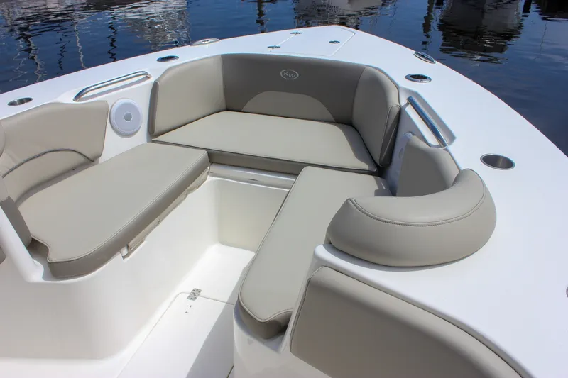 Slide: The Image of 2022 Key West 263 FS boat interior with cushioned seating and cup holders. - 32