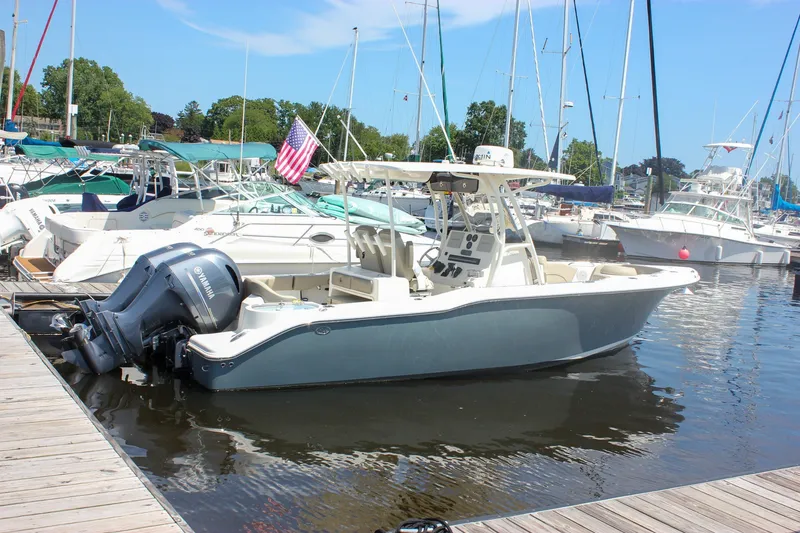Slide: The Image of 2022 Key West 263 FS boat docked in a marina with other vessels. - 47