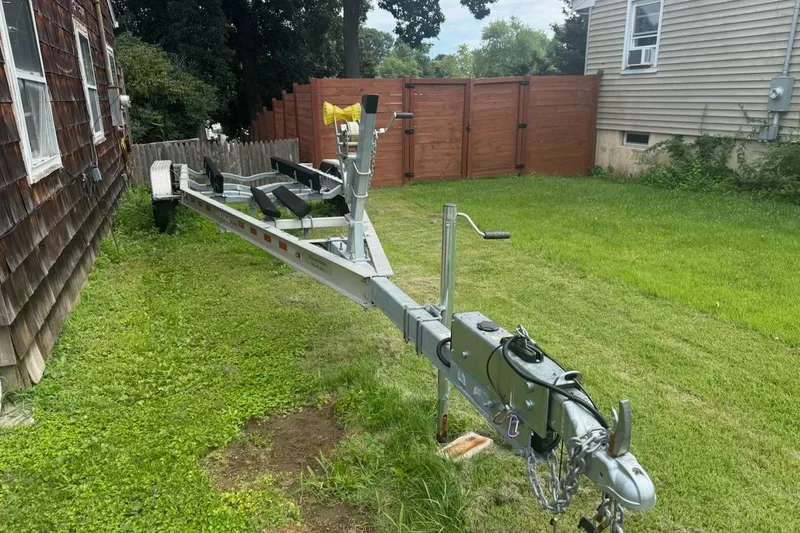 Slide: The Image of Trailer for 2022 Key West 263 FS boat parked on grass beside a house. - 45