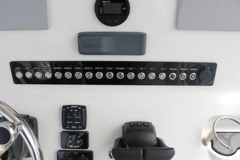 Slide: The Image of Control panel of 2022 Key West 263 FS boat with various switches and gauges. - 38