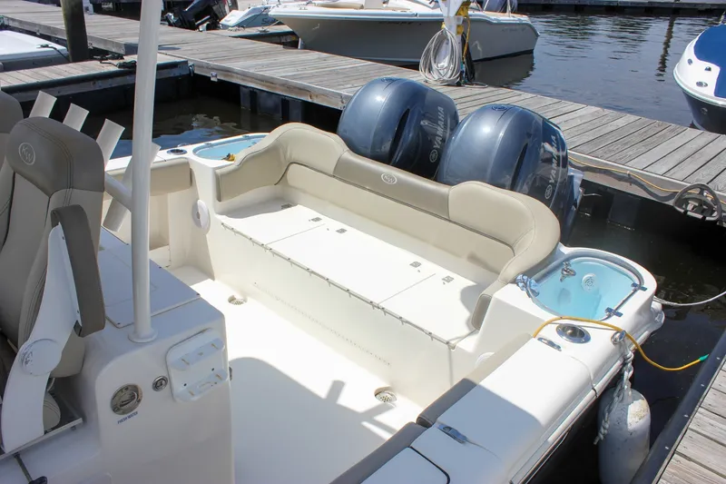 Slide: The Image of 2022 Key West 263 FS boat with dual Yamaha engines docked at marina. - 7