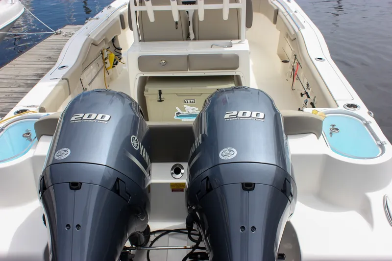 Slide: The Image of 2022 Key West 263 FS boat with dual Yamaha 200 engines, docked by the water. - 41