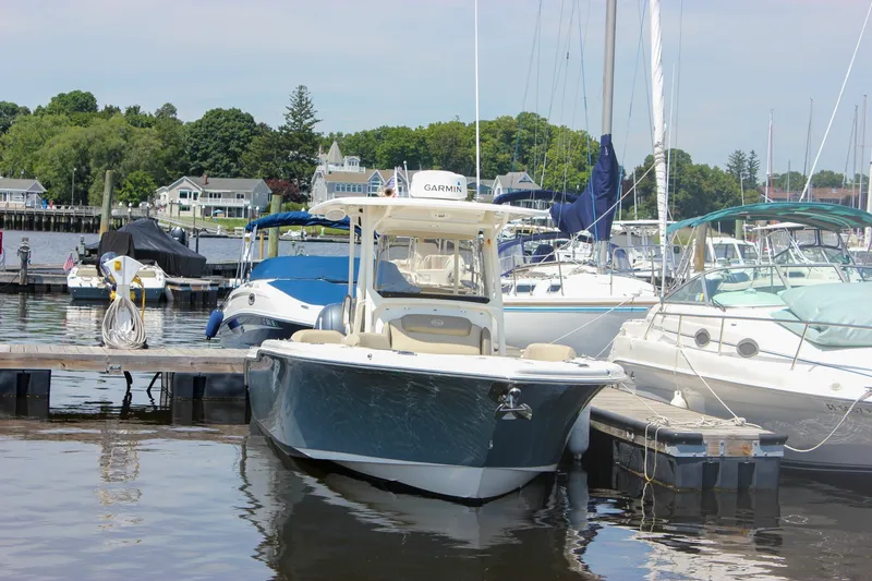 Slide: The Image of 2022 Key West 263 FS boat docked at a marina with surrounding yachts. - 46