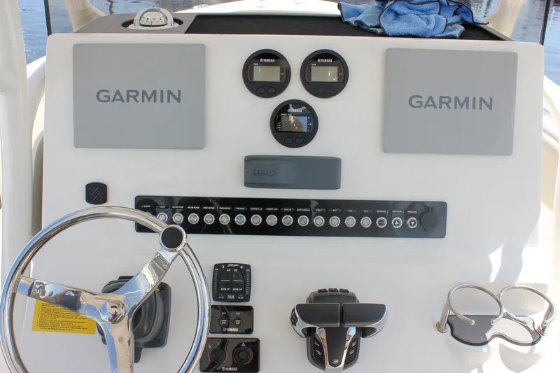 Slide: The Image of 2022 Key West 263 FS boat dashboard with Garmin displays and Yamaha controls. - 21