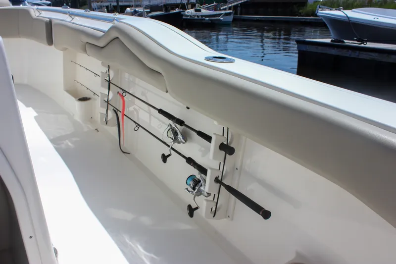 Slide: The Image of 2022 Key West 263 FS boat with fishing rod holders, docked by the water. - 15