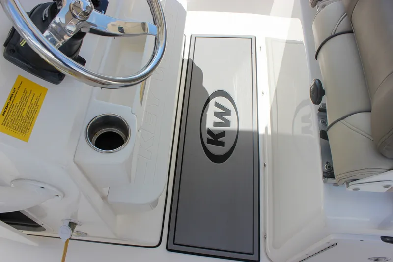 Slide: The Image of 2022 Key West 263 FS boat interior with steering wheel and KW logo mat. - 25