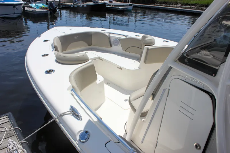 Slide: The Image of 2022 Key West 263 FS boat with spacious seating, docked on calm water. - 6