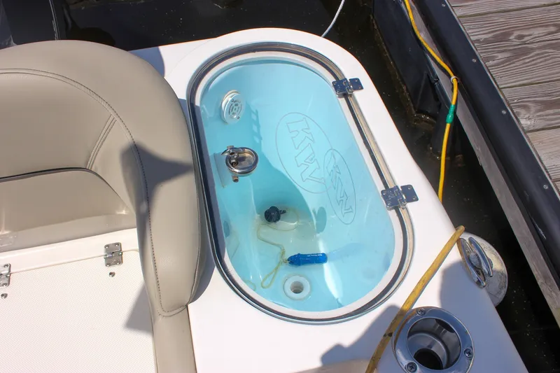Slide: The Image of Livewell on 2022 Key West 263 FS boat, featuring a clear lid and blue interior. - 11