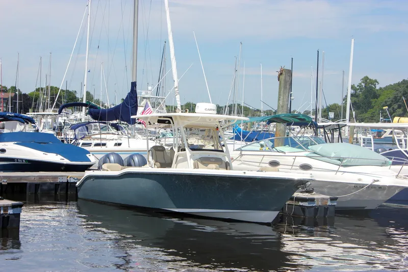 Slide: The Image of 2022 Key West 263 FS boat docked in a marina with other vessels. - 4