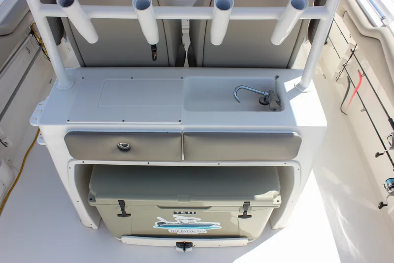 Slide: The Image of 2022 Key West 263 FS boat interior with fishing rod holders and storage. - 13
